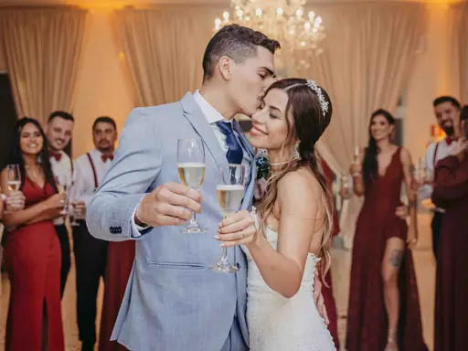 A couple sharing a kiss during a champagne toast